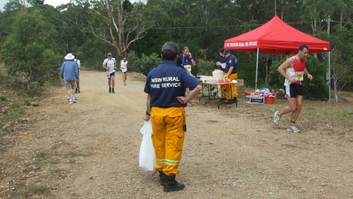 Ready with the rubbish bag to collect the abandoned drink cups from the Mt Riverview brigade drink station during the 2014 Six Foot Track Marathon. .